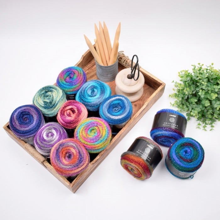 A wooden box filled with a variety of colorful yarn and knitting needles ideal for DIY crochet projects.